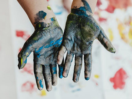 Hibiscus House Stuart, Kids hand covered in art paint, artist Donald Voelker