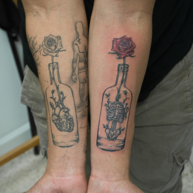 glass with rose and rib cage tattoo - endless heights tattoo by artist dj donald voelker