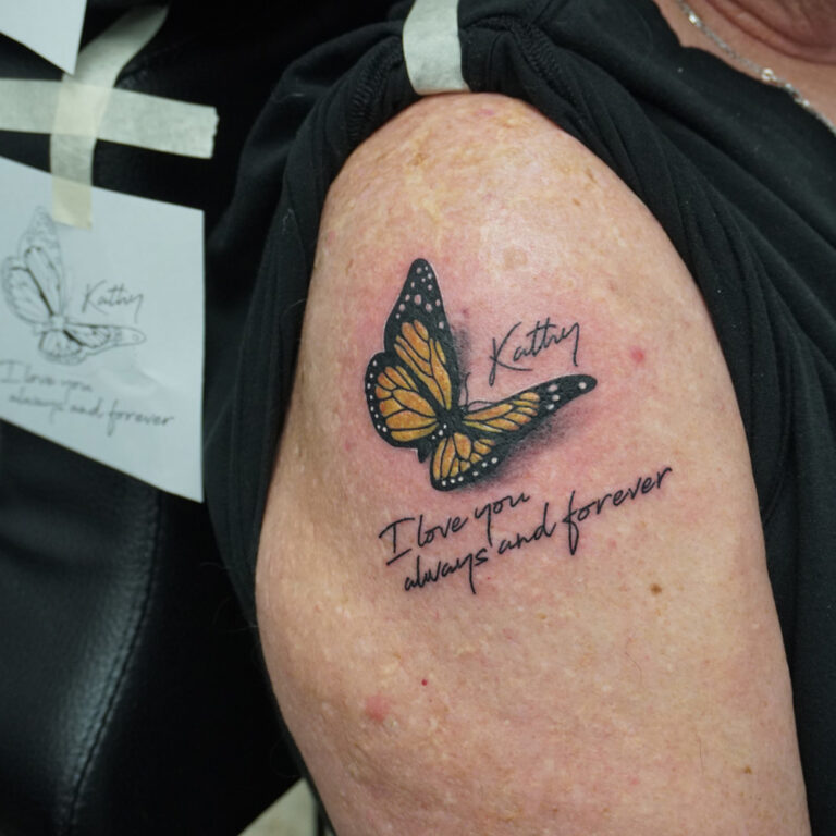 memorial tattoo, colored butterfly with text for his wife attoo - endless heights tattoo by artist dj donald voelker