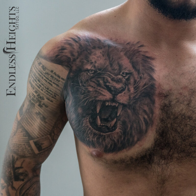 realism black and grey animal lion portrait on chest - endless heights tattoo by artist dj donald voelker