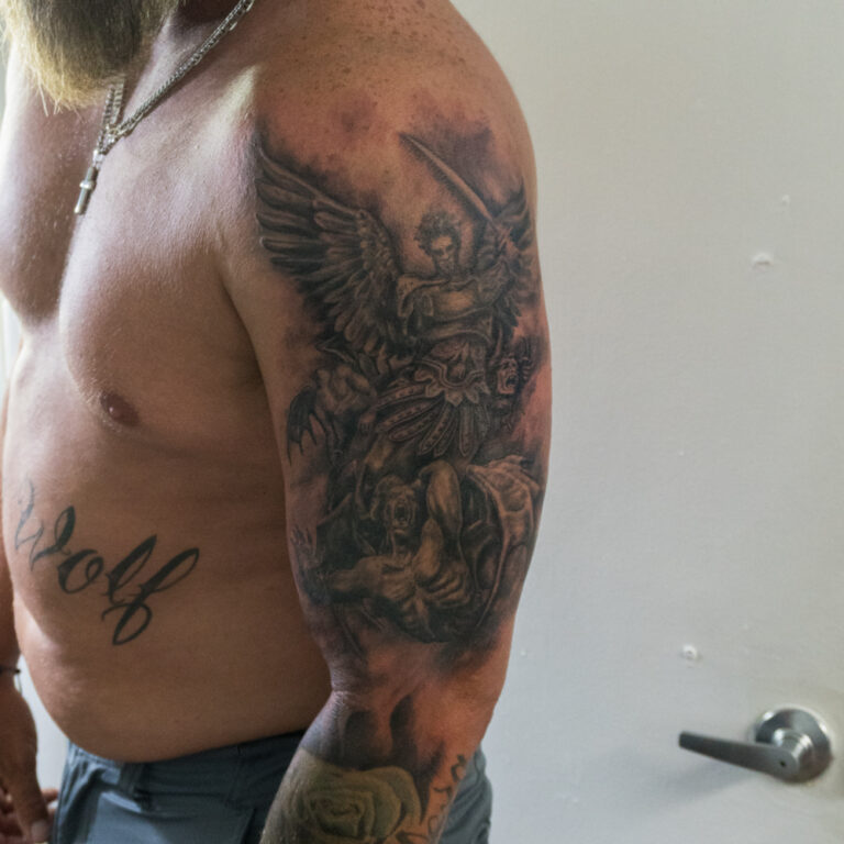 angel slaying demons tattoo on the outer shoulder - endless heights tattoo by artist dj donald voelker