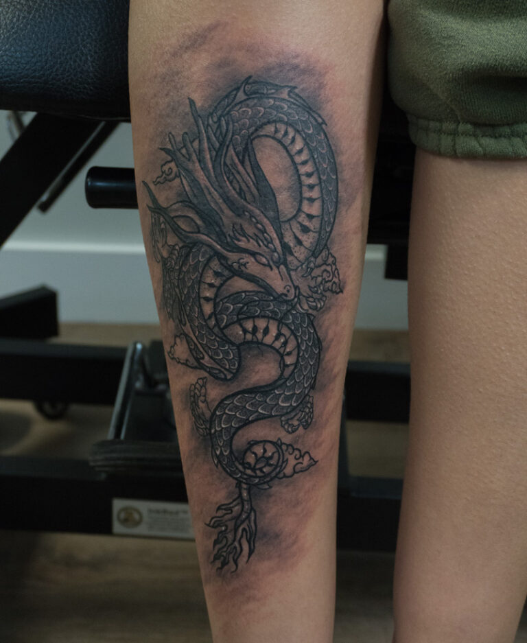 dragon tattoo on front shin - endless heights tattoo by artist dj donald voelker