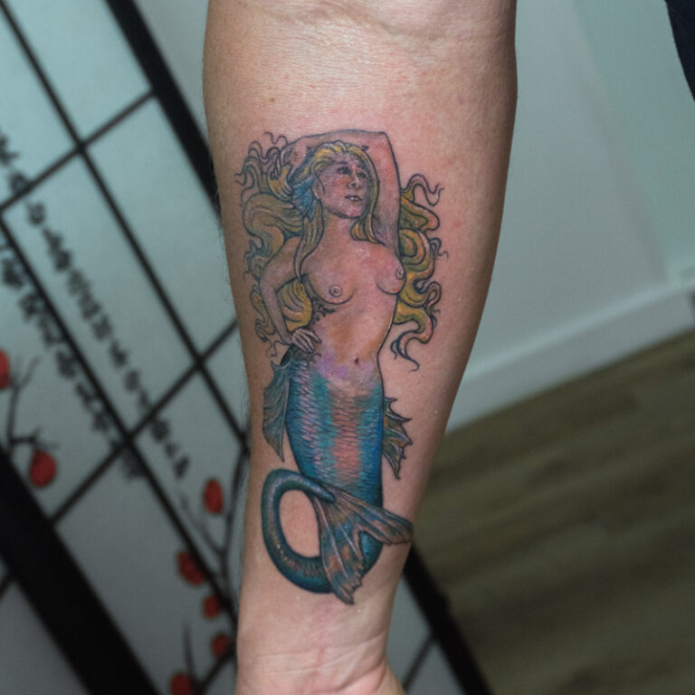 tribute tattoo, traditional color mermaid of his wife tattoodragon tattoo on front shin - endless heights tattoo by artist dj donald voelker