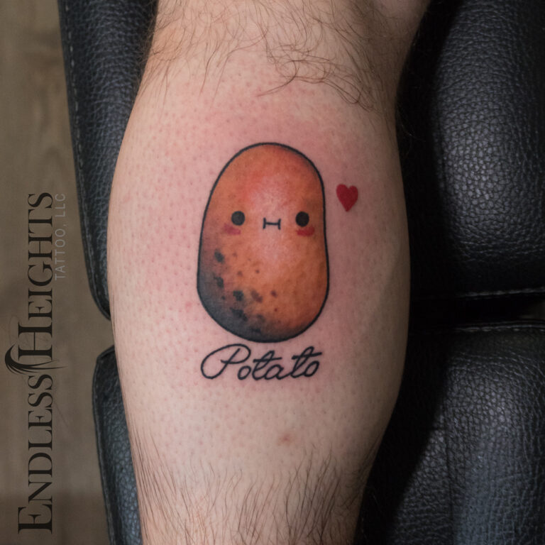 carttoon potato portrait in color, tribute to his son tattoo on the back of his calf - endless heights tattoo by artist dj donald voelker