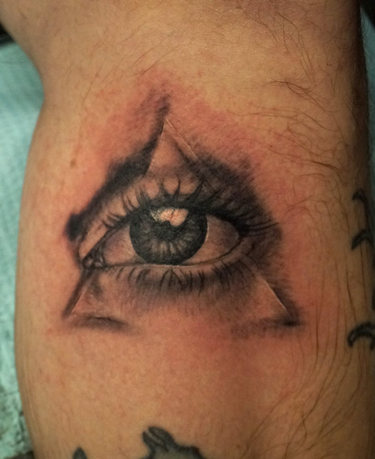 old seeing eye realism tattoo - endless heights tattoo by artist dj donald voelker