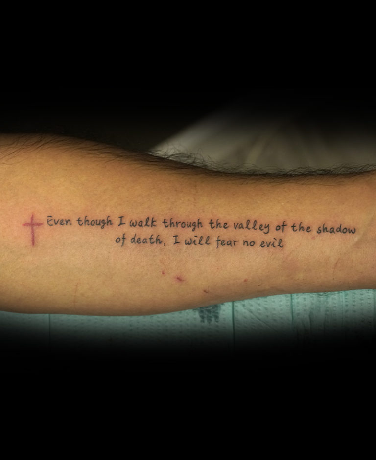 biblical tattoo, red cross with scripture text paragraph tattoo on forearm - endless heights tattoo by artist dj donald voelker