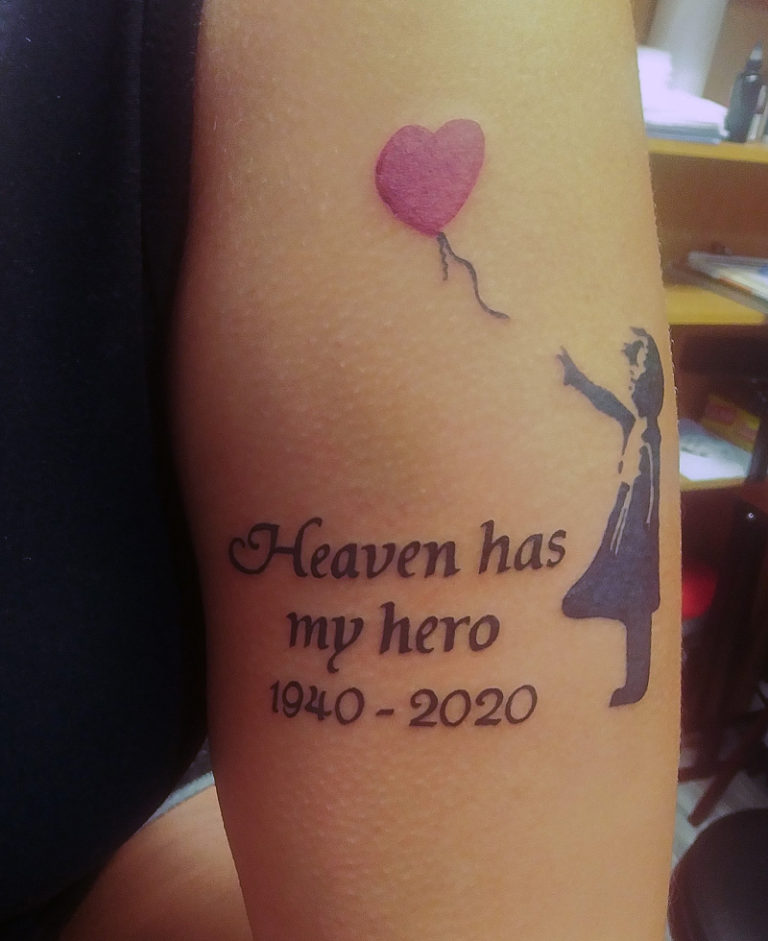 a banksy artwork child with balloon and text recreated as a memorial tattoo - endless heights tattoo by artist dj donald voelker